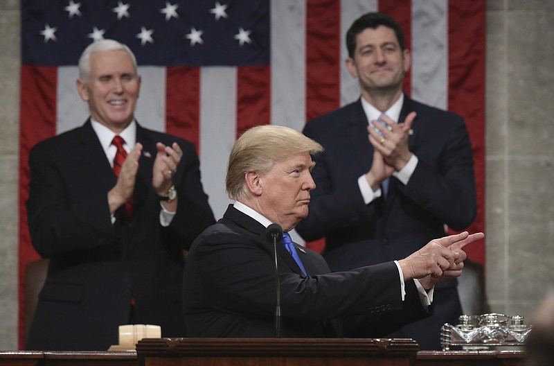 President Donald Trump points as delivers his first State of the Union address in the House chamber of the U.S. Capitol to a joint session of Congress Tuesday, Jan. 30, 2018 in Washington, as Vice President Mike Pence and House Speaker Paul Ryan applaud. (Win McNamee/Pool via AP)