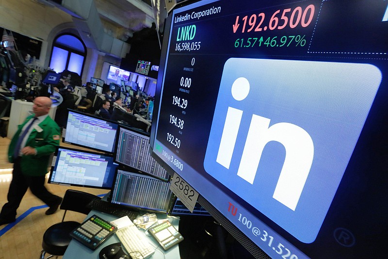 FILE - In this Monday, June 13, 2016, file photo, the LinkedIn logo appears on a screen at the post where it trades on the floor of the New York Stock Exchange. Microsoft will break out LinkedIn revenue when it reports its quarterly earnings Wednesday, Jan. 31, 2018. (AP Photo/Richard Drew, File)