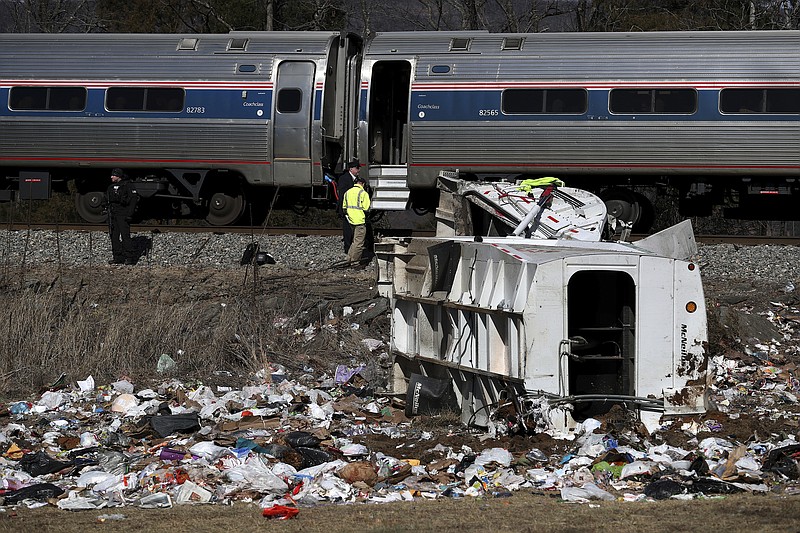 Emergency personnel work at the scene of a train crash involving a garbage truck in Crozet, Va., on Wednesday, Jan. 31, 2018. An Amtrak passenger train carrying dozens of GOP lawmakers to a Republican retreat in West Virginia struck a garbage truck south of Charlottesville, Va. No lawmakers were believed injured.   (Zack Wajsgrasu/The Daily Progress via AP)