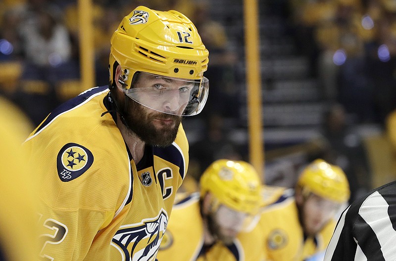 FILE - In this May 16, 2017, file photo, Nashville Predators center Mike Fisher (12) gets set for a faceoff against the Anaheim Ducks during the first period in Game 3 of the Western Conference final in the NHL hockey Stanley Cup playoffs in Nashville, Tenn.