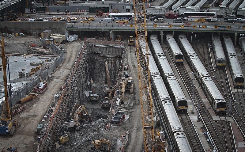 This April 17, 2014, file photo shows ongoing construction of a rail tunnel, left, at the Hudson Yards redevelopment site on Manhattan's west side in New York. Amtrak constructed a concrete box inside the project to preserve space for a tunnel from New Jersey to New York across the Hudson River. President Donald Trump called for a $1.5 trillion infrastructure investment in his State of the Union address on Tuesday, Jan. 30, 2018. Questions surrounding Trump's infrastructure plan are likely to leave costly projects, such as plans for the new Hudson River tunnel. (AP Photo/Bebeto Matthews, File)