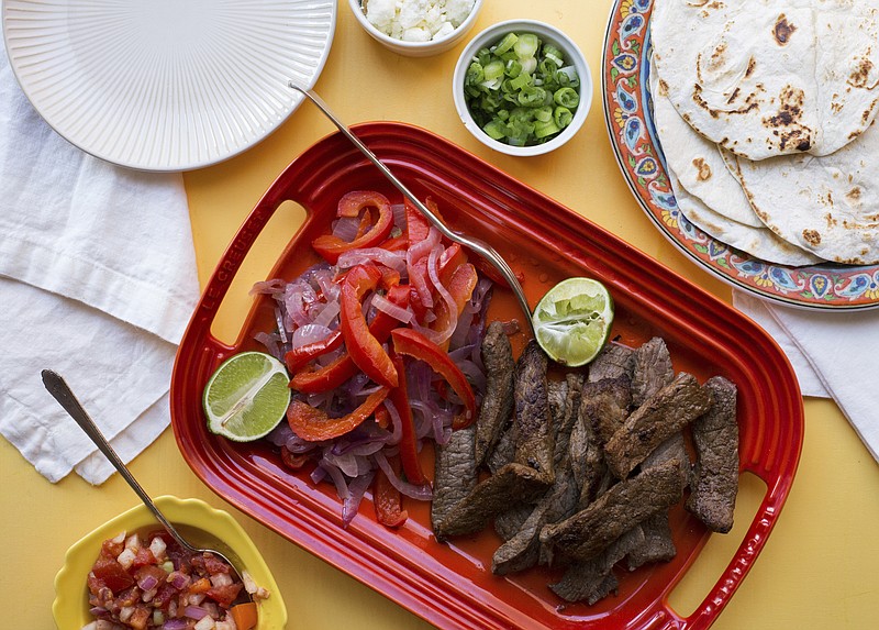 This November 2017 photo shows steak fajitas in New York. This dish is from a recipe by Katie Workman. (Sarah E Crowder via AP)