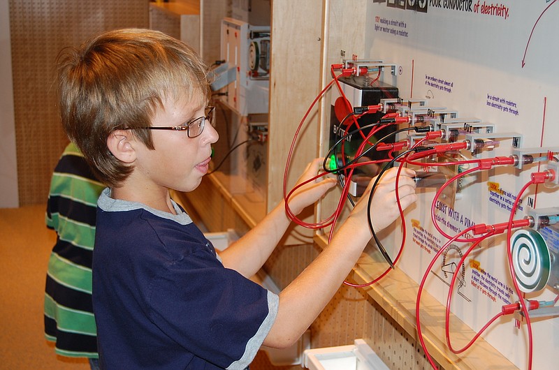 Nicholas Heeter of Holly Springs, Ga., connects circuits in an exhibit at the Tellus Science Museum during a home-school field trip.