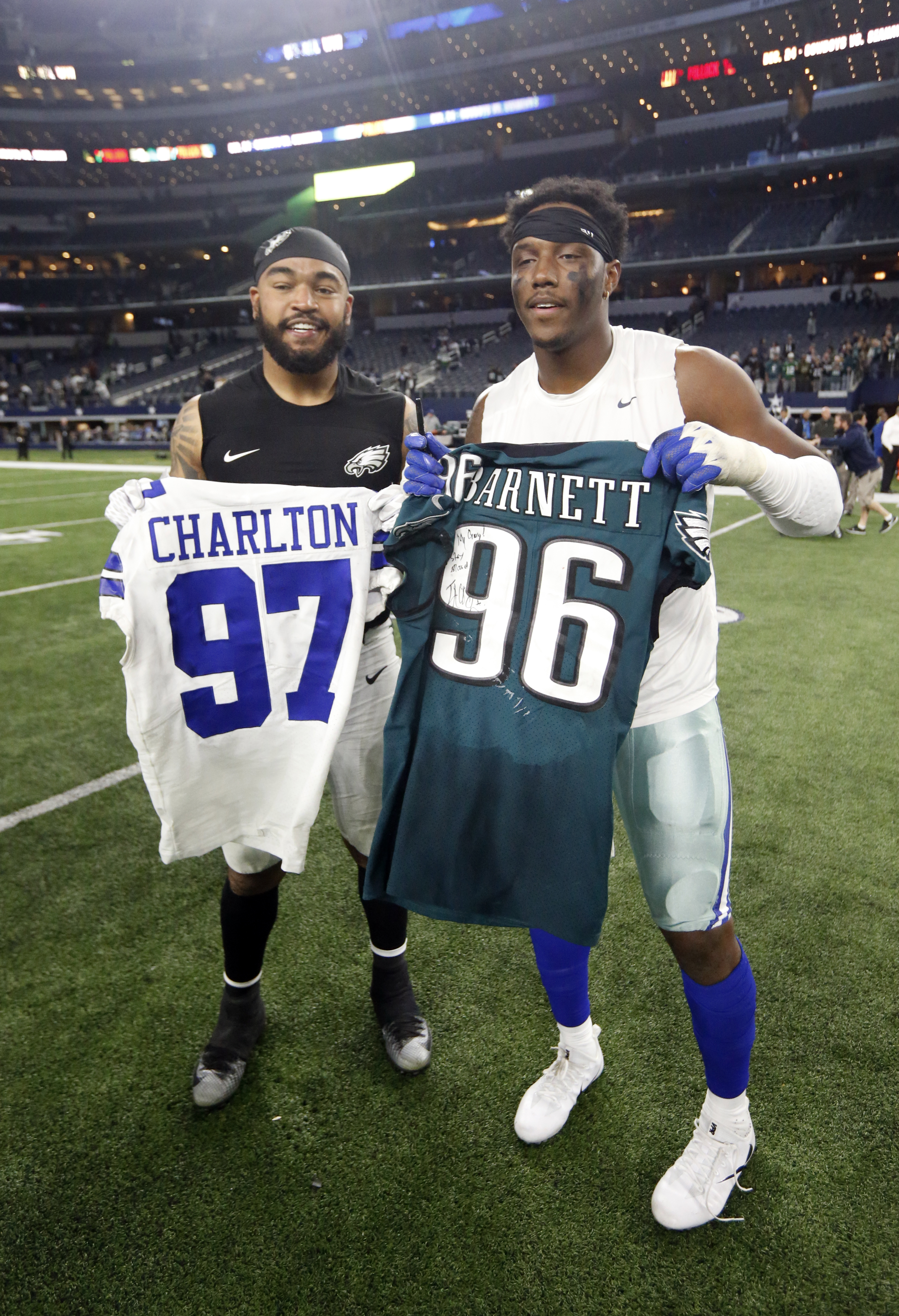 Philadelphia Eagles defensive end Derek Barnett, left, and Dallas Cowboys defensive end Taco Charlton, right, swap jerseys after their NFL football game, Sunday, Nov. 19, 2017, in Arlington, Texas. (AP Photo/Michael Ainsworth)