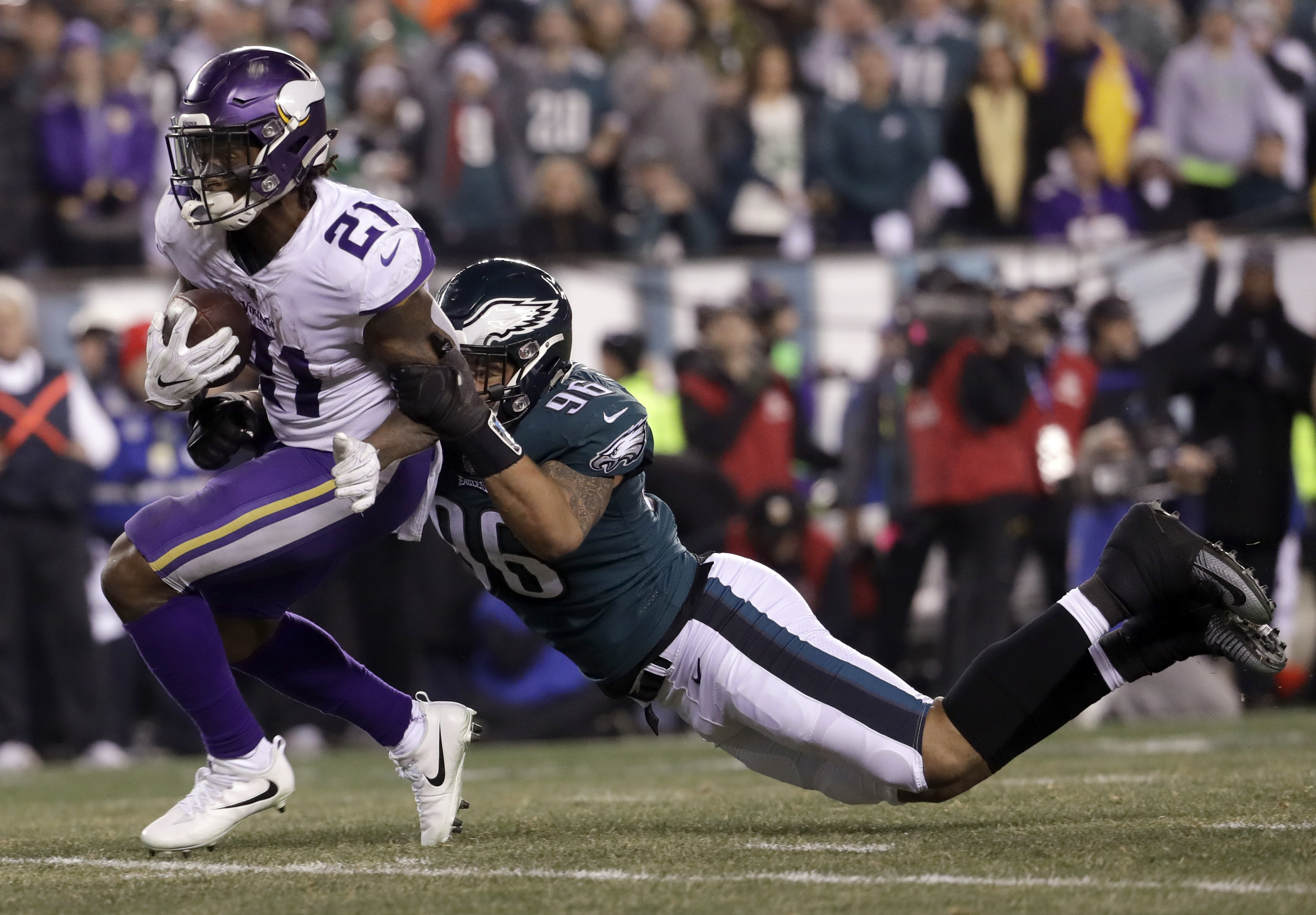 Minnesota Vikings' Jerick McKinnon is stopped by Philadelphia Eagles' Derek Barnett during the second half of the NFL football NFC championship game Sunday, Jan. 21, 2018, in Philadelphia. (AP Photo/Michael Perez)