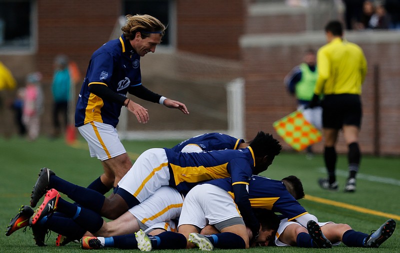 Chattanooga FC players pile on one another following the first-half goal by Zeca Ferraz that enabled the CFC to tie FC Dallas 1-1 Saturday afternoon at Finley Stadium.
