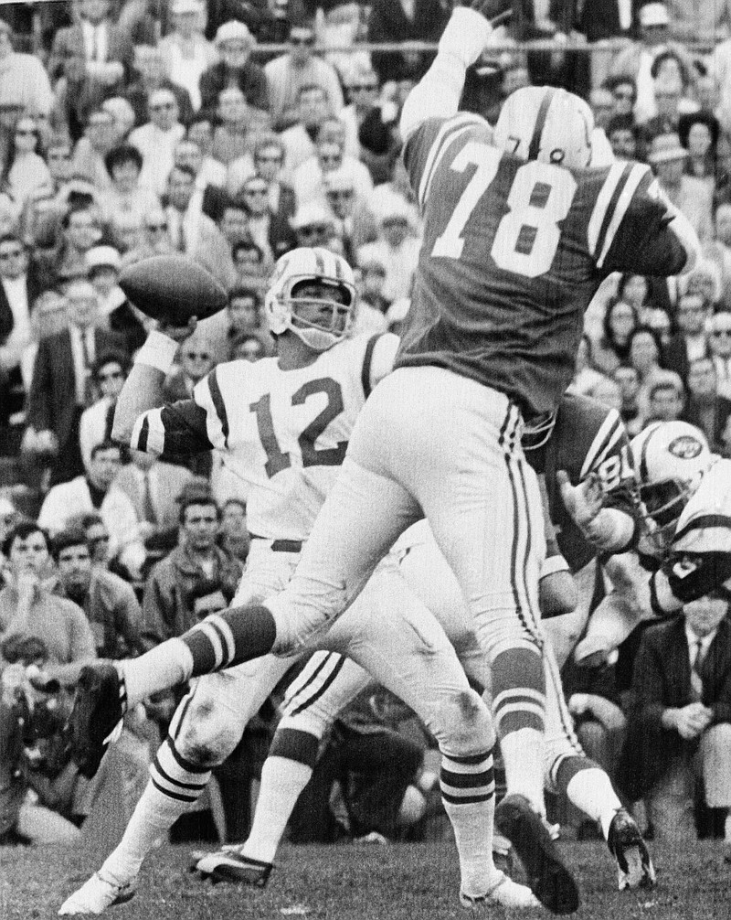 New York Jets quarterback Joe Namath throws the ball as Baltimore Colts defensive lineman Bubba Smith attempts to block the pass in Super Bowl III in Miami on Jan. 12, 1969.