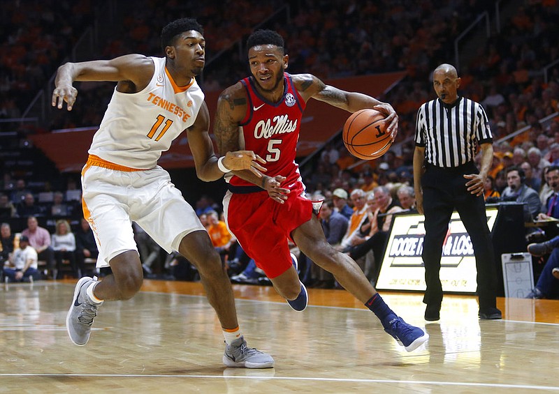 Mississippi guard Markel Crawford (5) drives the ball down the court beside Tennessee forward Kyle Alexander (11) in the first half of an NCAA college basketball game Saturday, Feb. 3, 2018, in Knoxville, Tenn. (AP Photo/Crystal LoGiudice)