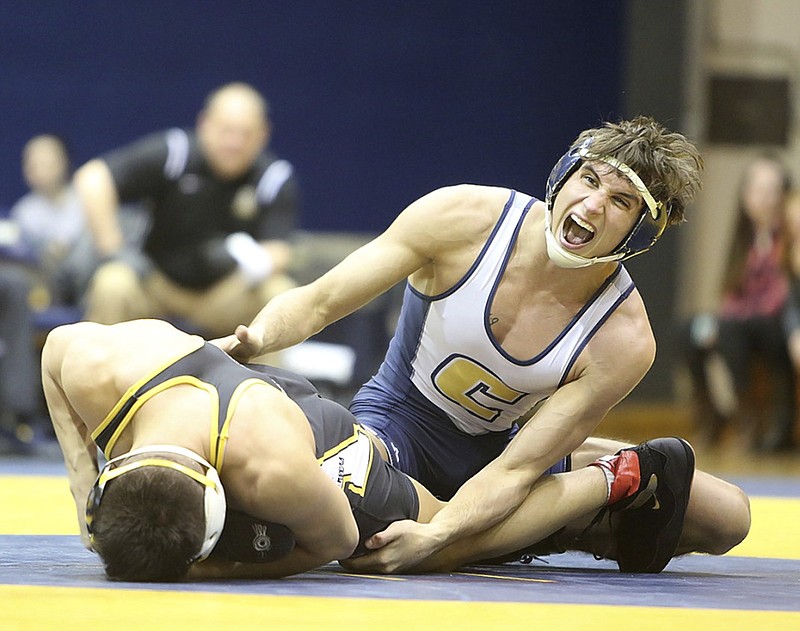 UTC's Michael Pongracz yells in pain as Appalachian State's Irvin Enriquez twists his leg during their 141-pound match on Sunday at McClellan Gym. Pongracz earned a major decision with a 9-1 victory, but Appalachian State won the dual 18-16.