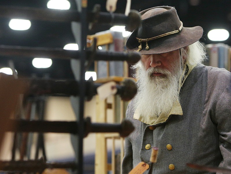 Markus Morgan, who is a re-enactor wearing a general's uniform, looks at viking swords as he passes a booth during the Chickamauga Civil War Show Sunday, Feb. 4, 2018 at the Dalton Convention Center in Dalton, Ga. This year marks the 23rd year for the Chickmauga Civil War Show. There were 500 tables set up with vendors, which is the largest it has ever been. 