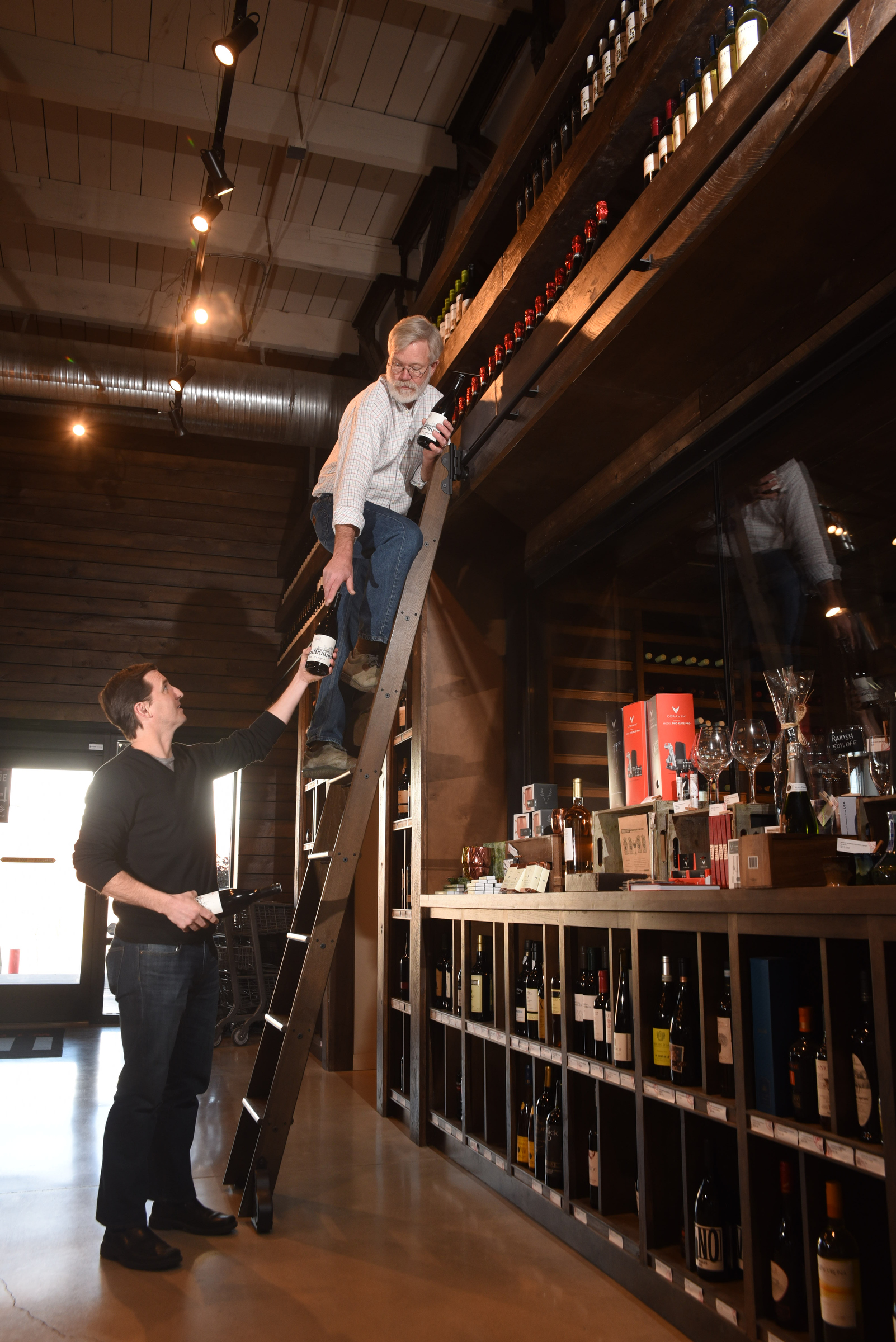 Business partner's Brian Leutwiler, top, and Josh Carter regulary stock a large selection of wines at Imbibe at 1616 Broad St.