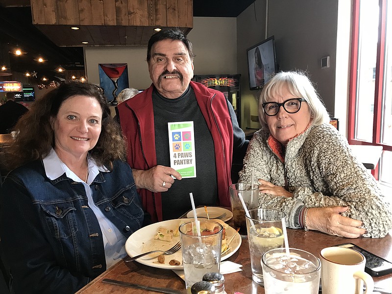 4 Paws Pet Food Pantry Social Media Manager Sandi Smith, board member Jim Samples and founder Betty Crawford, from left, gather at The Big Chill & Grill, which is hosting a fundraiser for the pantry Thursday, Feb. 8 from 6-8:30 p.m. (Contributed photo)