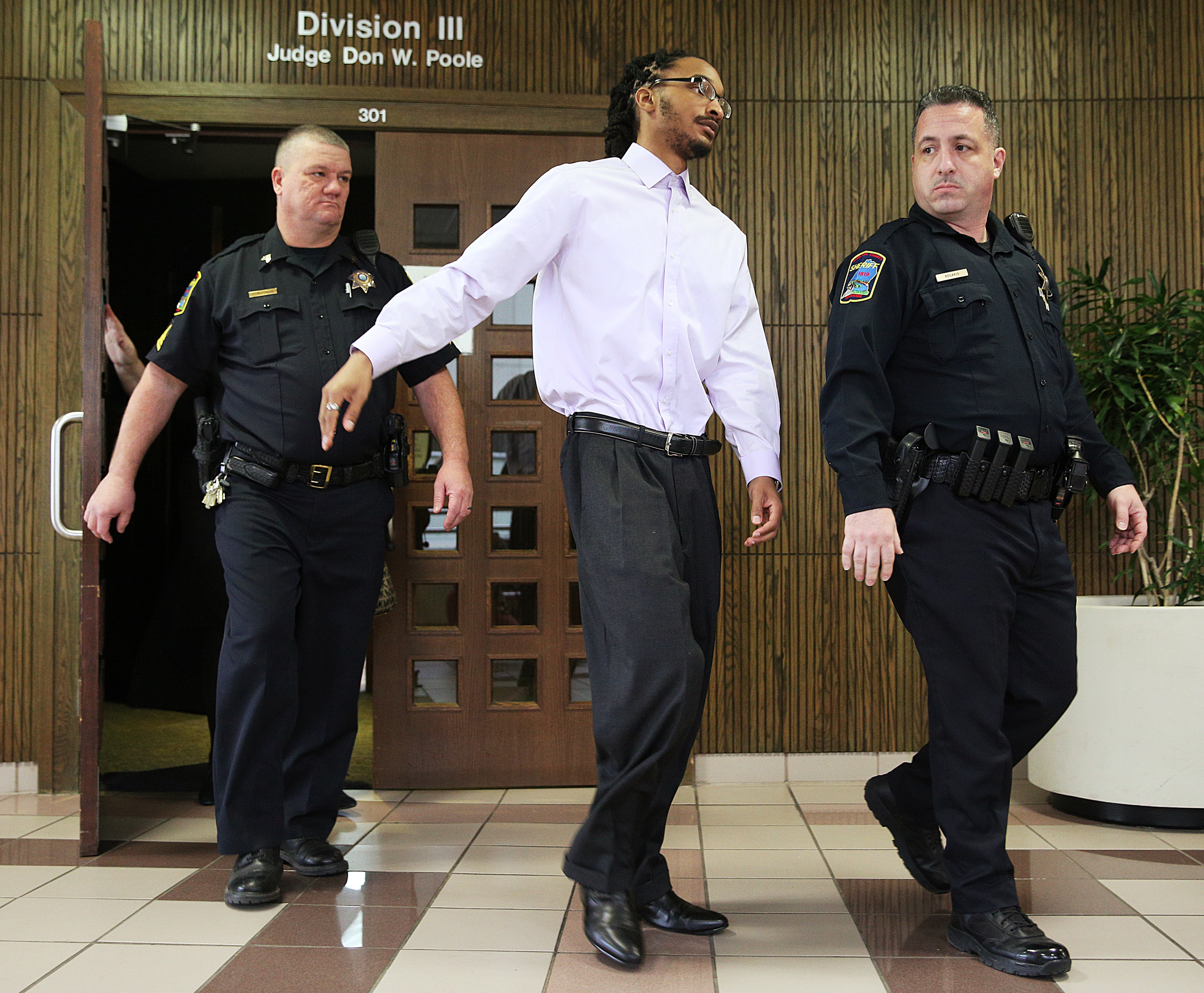 Johnthony Walker leaves the Hamilton County Criminal Courthouse with Hamilton County Sheriff's deputies following a pretrial hearing in Walker's case Monday, Feb. 5, 2018 in Judge Don Poole's courtroom at the Hamilton County Criminal Courthouse in Chattanooga, Tenn. Walker was the bus driver in the Nov. 21, 2016 fatal bus crash that killed six Woodmore Elementary Students.