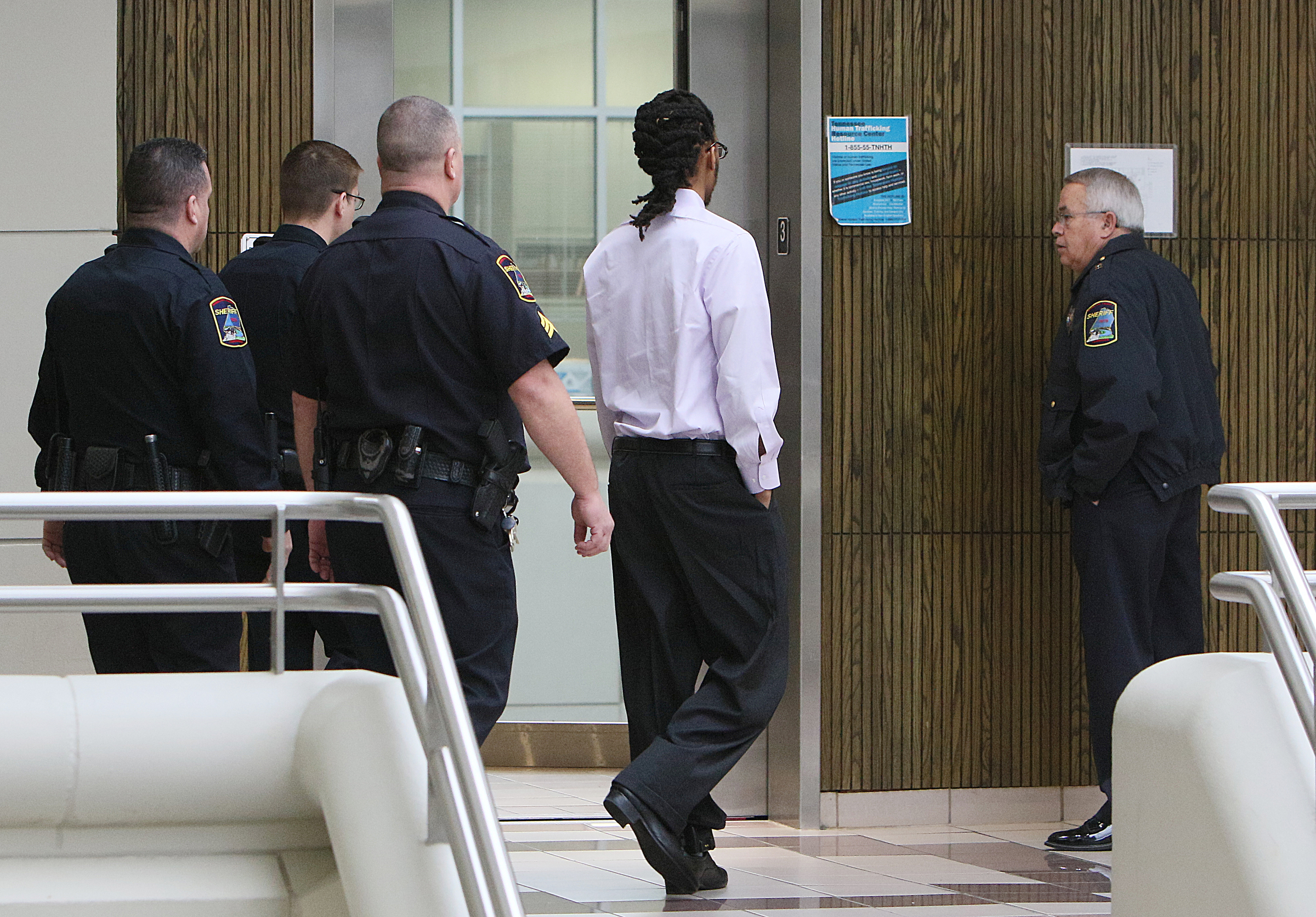Johnthony Walker leaves the Hamilton County Criminal Courthouse with Hamilton County Sheriff's deputies following a pretrial hearing in Walker's case Monday, Feb. 5, 2018 in Judge Don Poole's courtroom at the Hamilton County Criminal Courthouse in Chattanooga, Tenn. Walker was the bus driver in the Nov. 21, 2016 fatal bus crash that killed six Woodmore Elementary Students.
