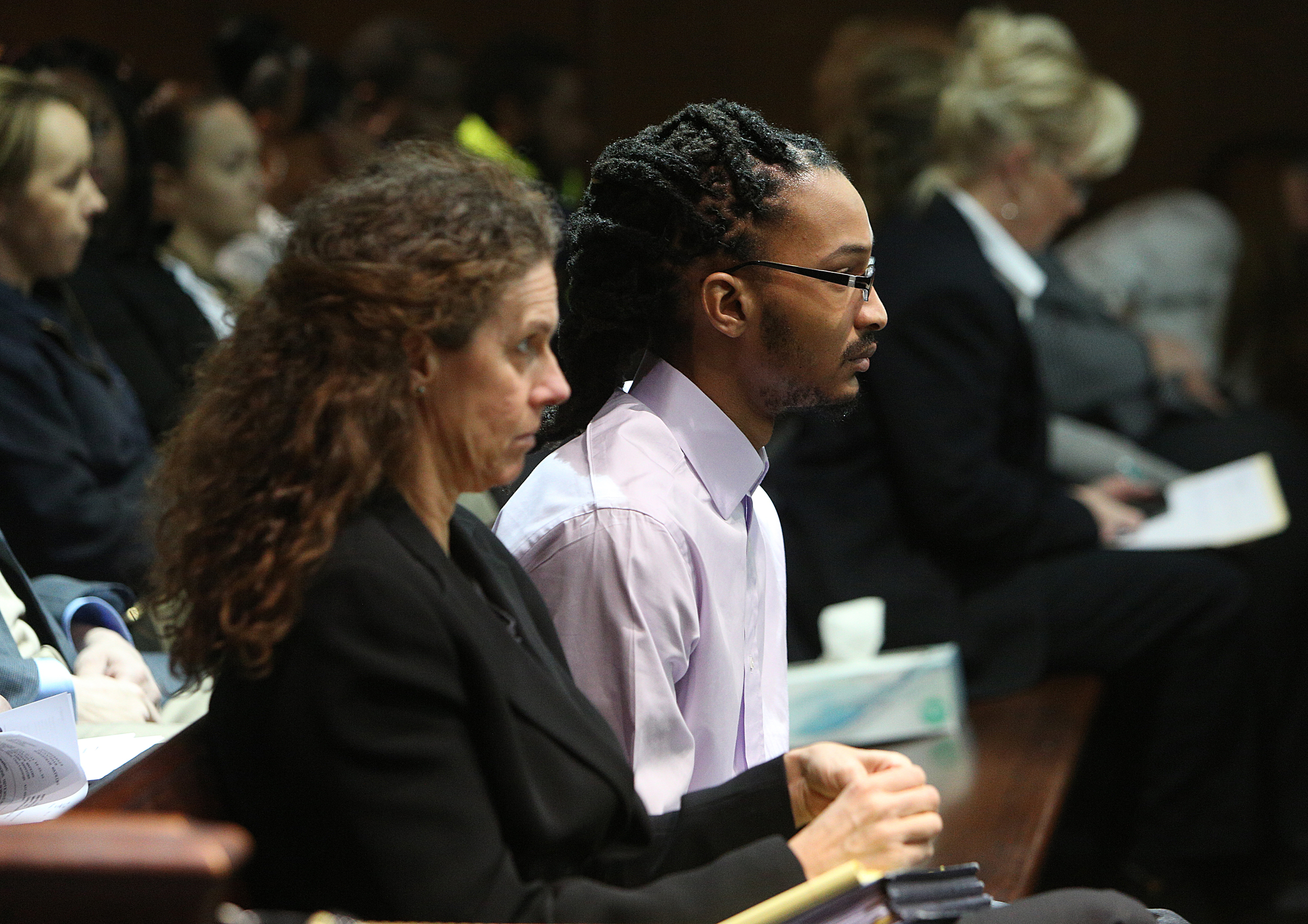Johnthony Walker sits in a bench near the front of Judge Don Poole's courtroom as he awaits his turn to be called up for a pretrial hearing Monday, Feb. 5, 2018 at the Hamilton County Criminal Courthouse in Chattanooga, Tenn. Walker was the bus driver in the Nov. 21, 2016 fatal bus crash that killed six Woodmore Elementary Students.