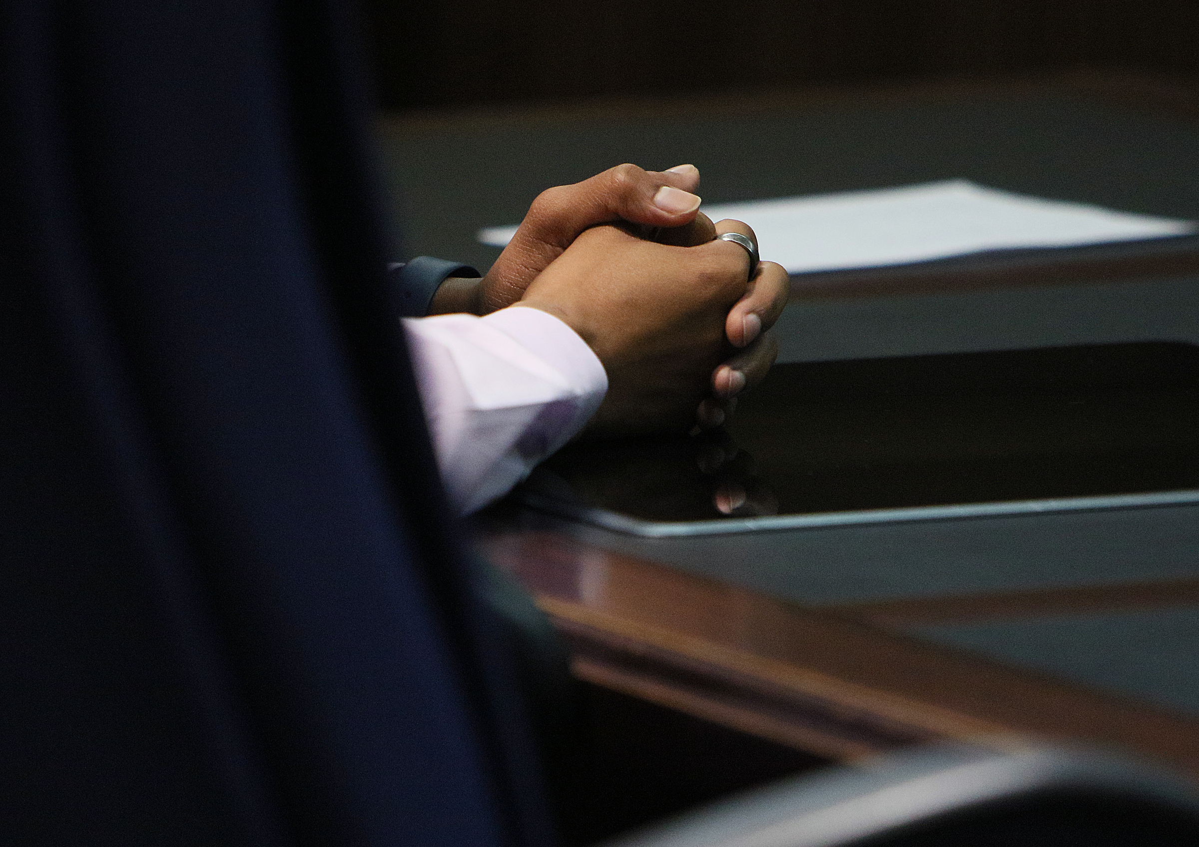 Johnthony Walker sits at a table in the front of the Judge Don Poole's courtroom with his hands clasped together during a pretrial hearing for Walker's case Monday, Feb. 5, 2018 at the Hamilton County Criminal Courthouse in Chattanooga, Tenn. Walker was the bus driver in the Nov. 21, 2016 fatal bus crash that killed six Woodmore Elementary Students.