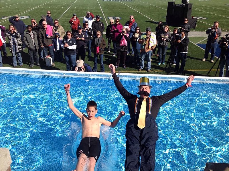 A grandfather and grandson fall back into the freezing pool at a prior Polar Plunge.