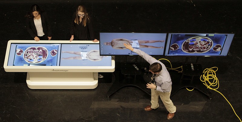 Students Olivia Dillard, left, and Mattie Jones help science teacher Drew German demonstrate an Anatomage table in the auditorium at Bradley Central High School on Monday, Feb. 5, 2018 in Cleveland, Tenn. The Anatomage virtual dissection table allows students in health and science courses to manipulate real-life, virtual human cadavers.
