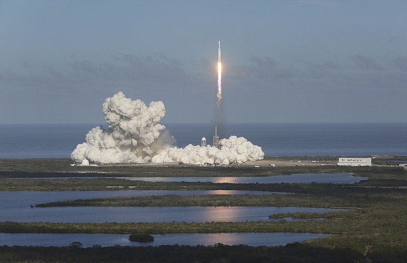 A SpaceX's Falcon Heavy rocket lifts off from launch Pad 39A Tuesday, Feb. 6, 2018, for the maiden demonstration test flight at the Kennedy Space Center. The big rocket is made up of three rocket boosters that will produce more thrust than any other rocket now flying. (Red Huber /Orlando Sentinel via AP)