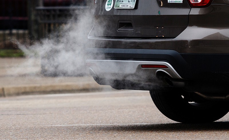 Exhaust streams from an SUV traveling on Market Street downtown on Tuesday, Feb. 6, 2018, in Chattanooga, Tenn. 