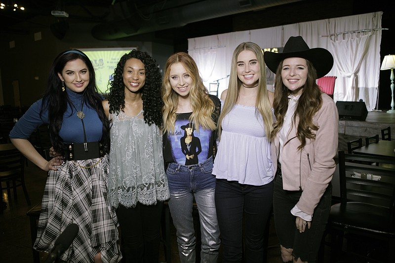 In this Jan. 29, 2018 photo provided by Song Suffragettes, Inc., members of the Song Suffragettes, from left, Candi Carpenter, Tiera Leftwich, Kalie Shorr, Chloe Gilligan and Jenna Paulette pose for a photo in Nashville, Tenn. Female musicians in Nashville have long complained about the lack of representation on country radio, but now a collective of female songwriters are singing "Time's Up." Nearly two dozen women, all belonging to the Song Suffragettes collective, sang on the "Time's Up" song and music video released earlier this month. (Quinton Cook/Song Suffragettes, Inc. via AP)

