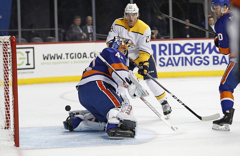 Nashville Predators left wing Kevin Fiala (22) of Switzerland watches as his shot slips behind New York Islanders goaltender Jaroslav Halak (41) of Slovakia during the first period of an NHL hockey game in New York, Monday, Feb. 5, 2018. (AP Photo/Kathy Willens)
