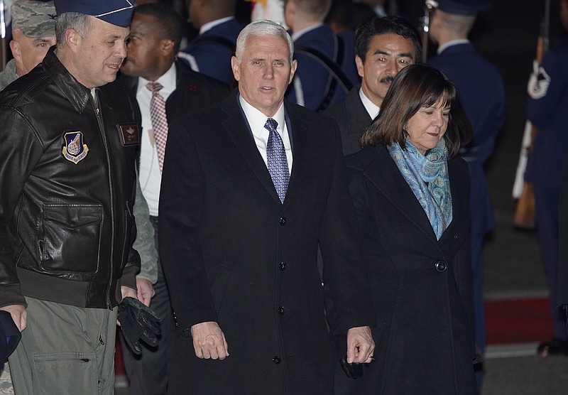 U.S. Vice President Mike Pence and his wife Karen walk upon their arrival at Yokota Air Base on the outskirts of Tokyo, Tuesday, Feb. 6, 2018.