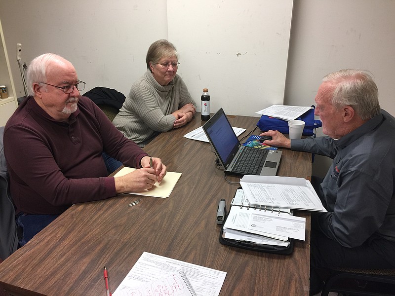 Donald and Ann Fritz, left, get free help on their taxes from George Davenport at an AARP tax center at the Bessie Smith Performance Hall.