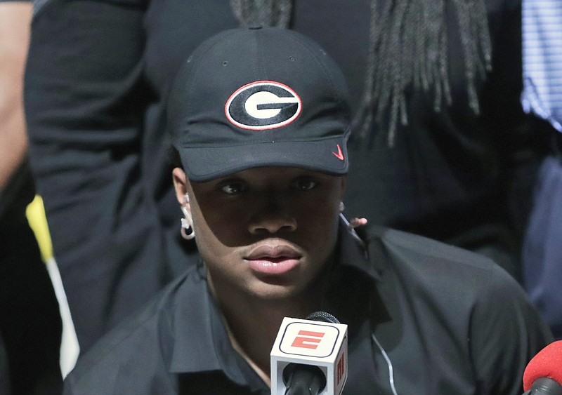 Tyson Campbell, a defensive back from the football team at American Heritage High School, announces he is signing with Georgia on national signing day, Wednesday, Feb. 7, 2018, in Plantation, Fla. (AP Photo/Lynne Sladky)