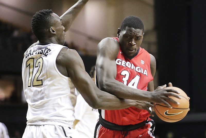 Georgia forward Derek Ogbeide (34) drives against Vanderbilt center Djery Baptiste (12) in the first half of an NCAA college basketball game Wednesday, Feb. 7, 2018, in Nashville, Tenn. (AP Photo/Mark Humphrey)