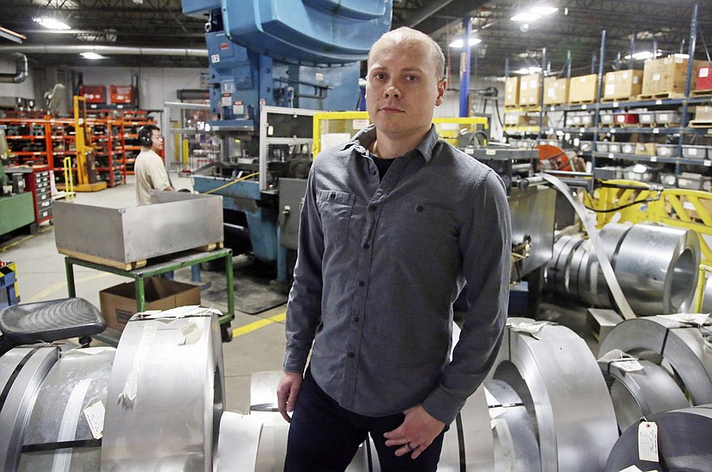 Andrew Tjernlund, a co-owner of Tjernlund Products, which manufactures fans and ventilation equipment, poses for a photo at his business in White Bear Lake, Minn. "The tax cut allows us to invest more in our growing business," he says. "In this low-unemployment environment, securing and rewarding our employees is the best use of this freed-up money." (AP Photo/Jim Mone)