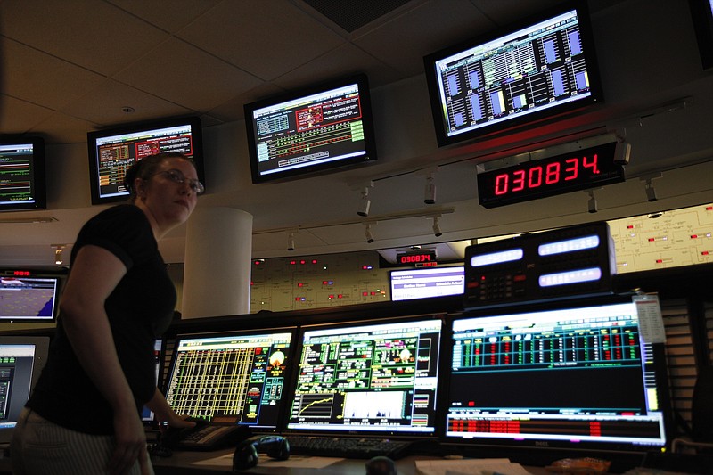 Staff Photo by Doug Strickland/Chattanooga Times Free Press - June 29, 2012.  Balancing authority Cheryl Roman works at a computer station to match power load and generation as a digital display shows a current total load of over 30,000 megawatts in the TVA System Operations Center at TVA headquarters in Chattanooga, Tenn. on Friday.  Several days of temperatures above 100 degrees will push TVA's power demands over the weekend.