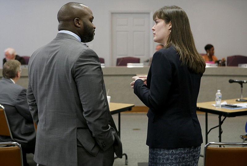 Superintendent Bryan Johnson, left, and Education Commissioner Candice McQueen talk before a work session at Hamilton County Schools' central office on Thursday, Feb. 8, 2018 in Chattanooga, Tenn. McQueen presented the state's plan to help the district's historically failing schools.