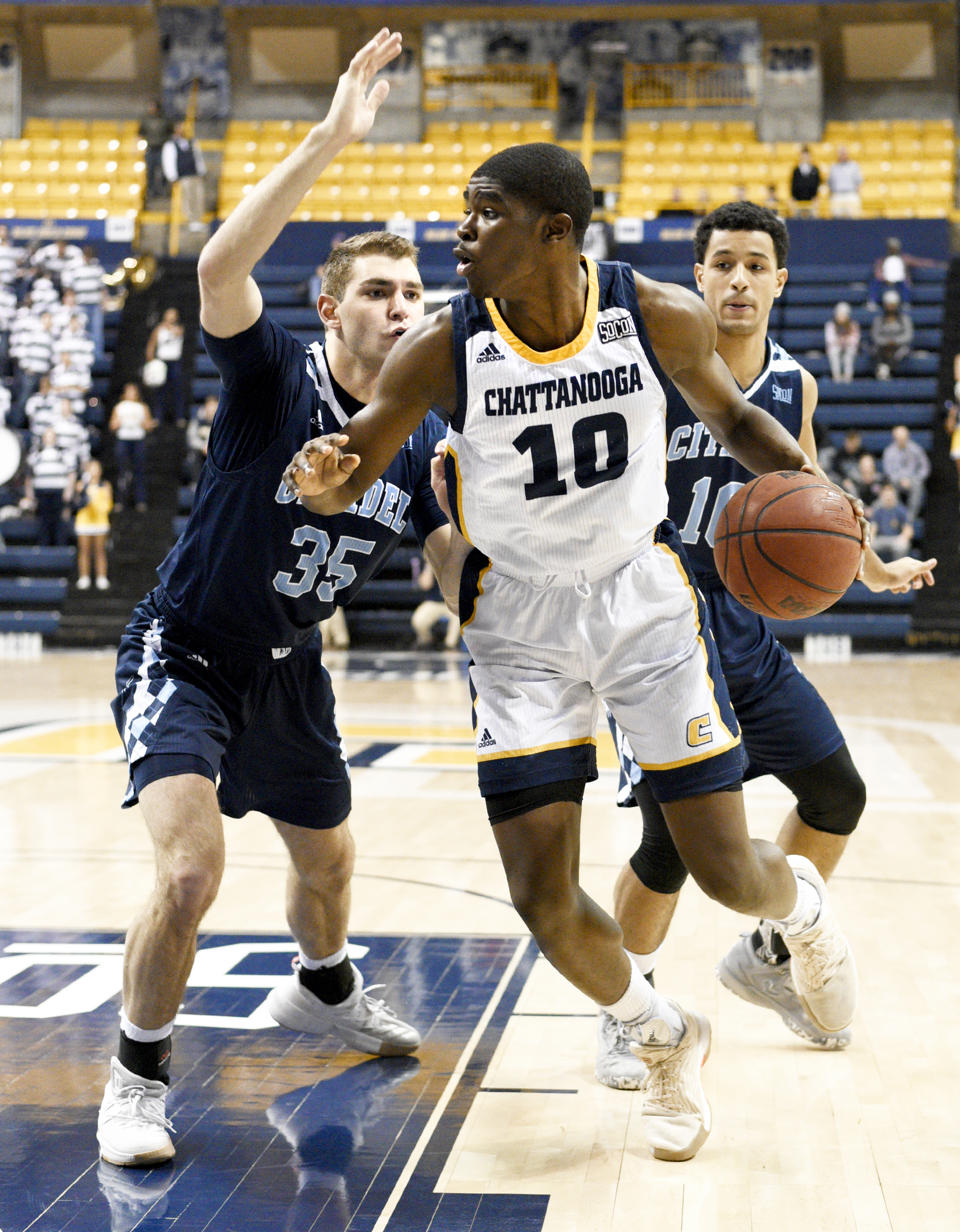UTC's James Lewis Jr. (10) gets inside The Citadel's Zane Najdawi (35) and Leandro Allende (10). The Citadel Bulldogs visited the University of Tennessee Chattanooga Mocs in Southern Conference basketball action at McKenzie Arena in Chattanooga, Tennessee on February 8, 2018.