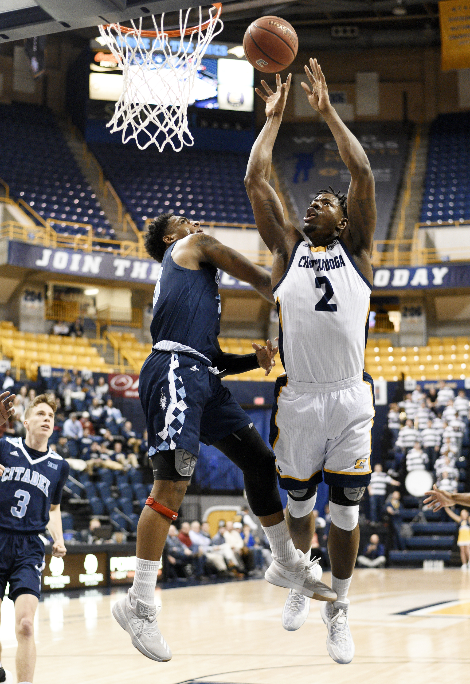 UTC's Joshua Phillips (2) shoots over The Citadel's Kaelon Harris during the Mocs' 85-82 win Thursday night at McKenzie Arena. Phillips scored 14 points.