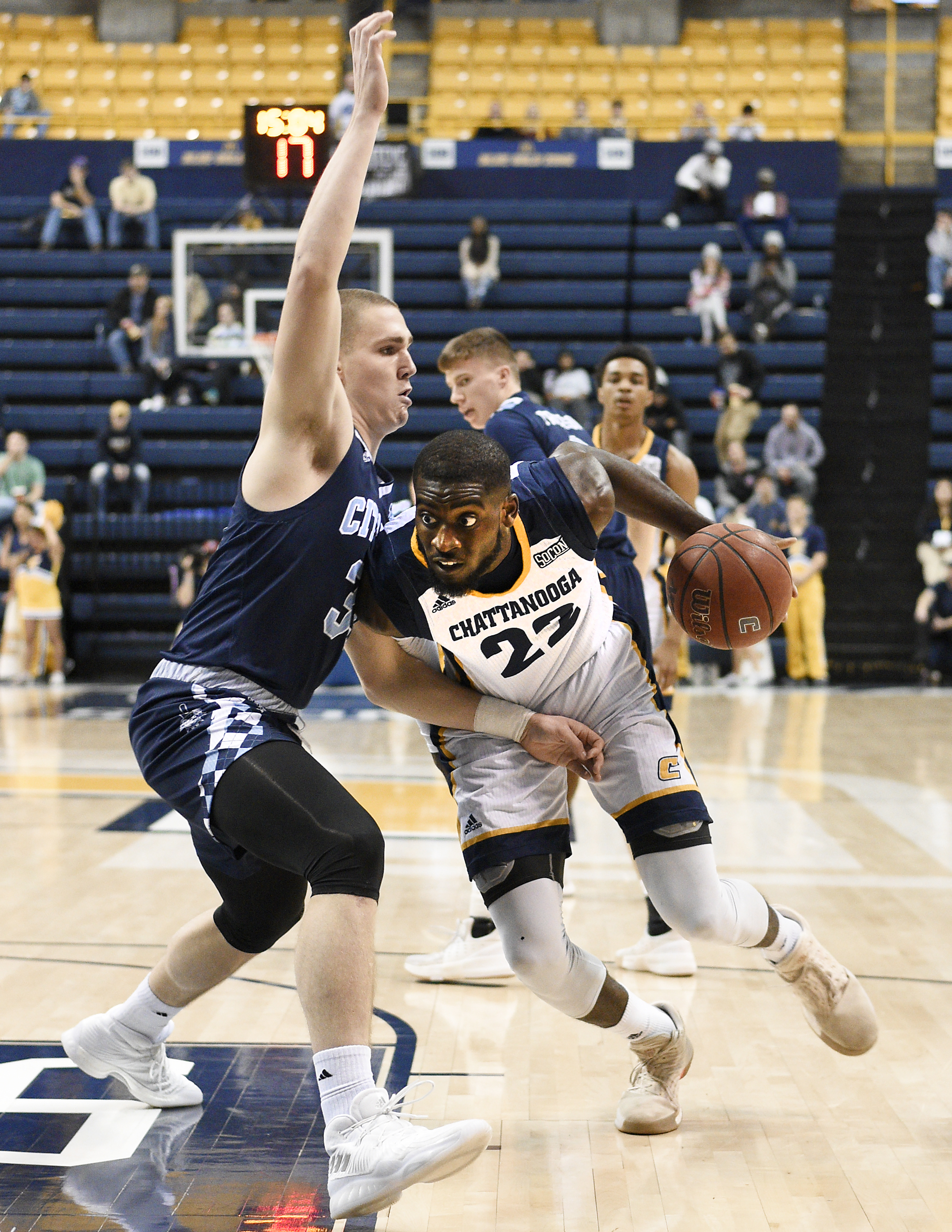 UTC's Makinde London (22) attempts to drive to the basket but is blocked by The Citadel's Matt Frierson (3). The Citadel Bulldogs visited the University of Tennessee Chattanooga Mocs in Southern Conference basketball action at McKenzie Arena in Chattanooga, Tennessee on February 8, 2018.