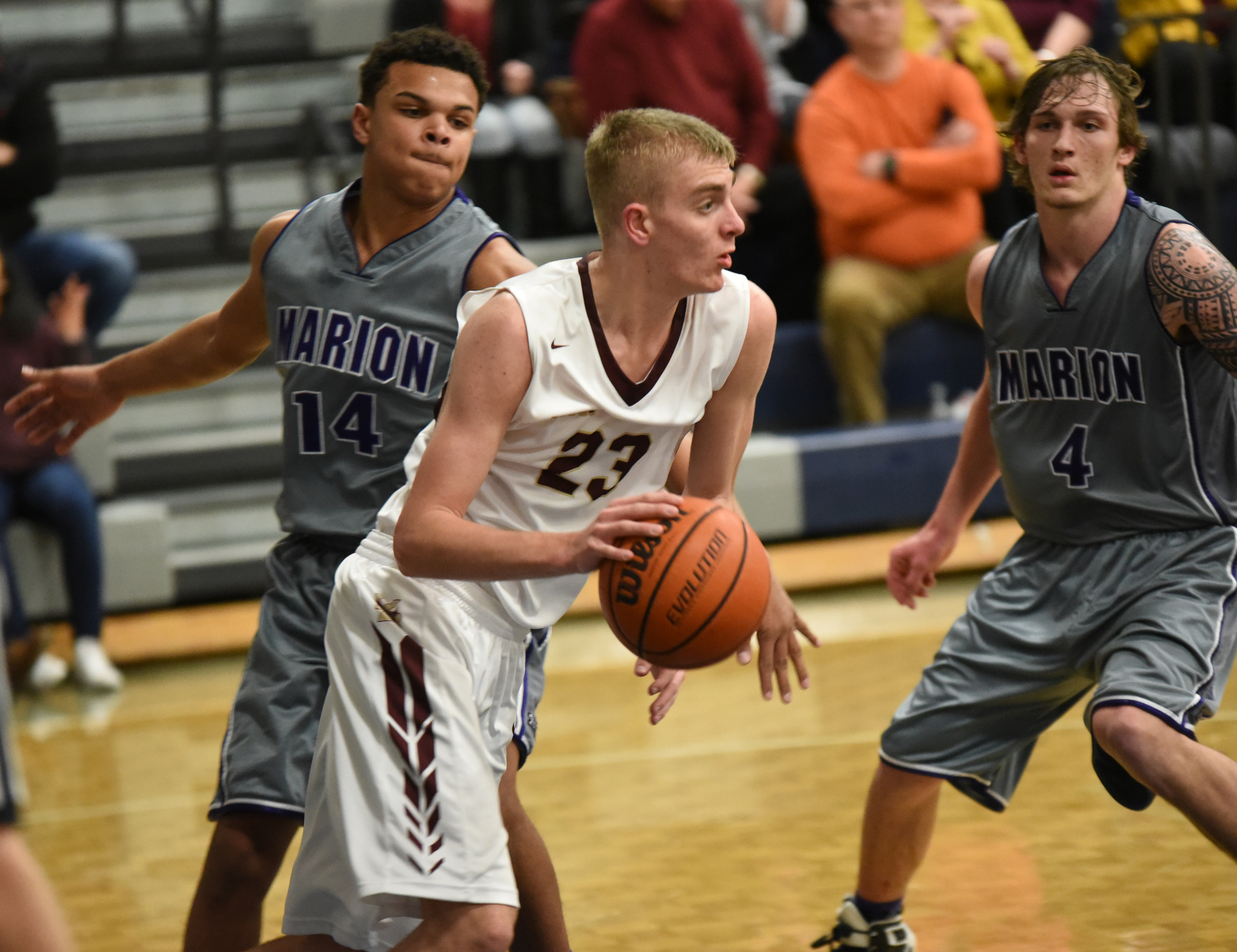 Van Buren's Caden Mills (23) clears after a rebound as Marion County's Kane Hale (14) and Logan Walters defend Thursday at Arts and Sciences. Van Buren won the Region 3-A boys' basketball championship 53-47, over Marion.