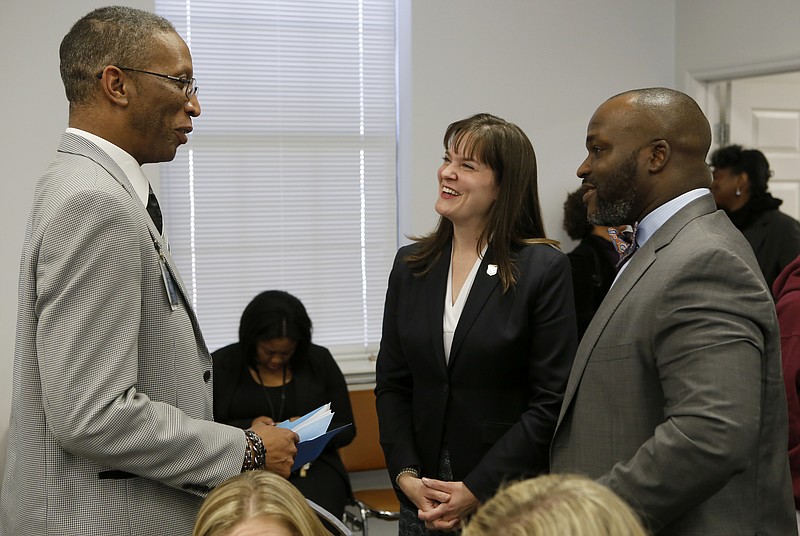 Orchard Knob Elementary School Principal Lafrederick Thirkill, left, speaks with Education Commissioner Candice McQueen, center, and Superintendent Bryan Johnson before a work session at Hamilton County Schools' central office on Thursday, Feb. 8, 2018 in Chattanooga, Tenn. McQueen presented the state's plan to help the district's historically failing schools.