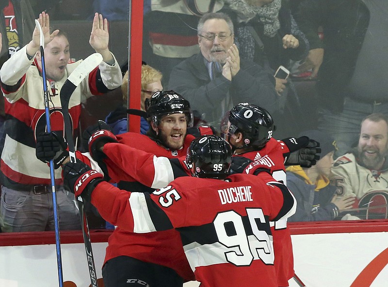 Ottawa Senators' Mike Hoffman (68) celebrates his winning overtime goal against the Nashville Predators with teammates Matt Duchene (95) and Thomas Chabot (72) NHL hockey game action in Ottawa, Ontario, Thursday, Feb. 8, 2018. (Fred Chartrand/The Canadian Press via AP)