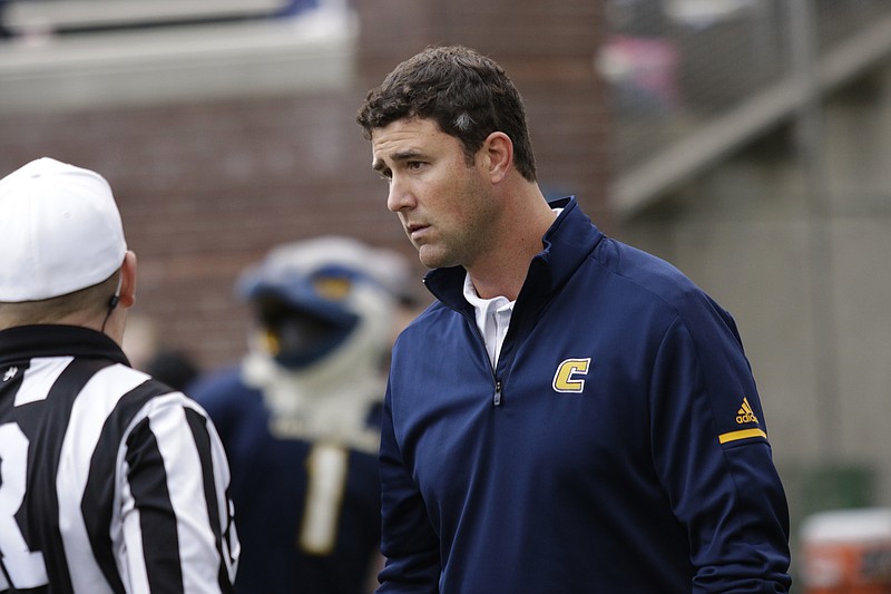 UTC head football coach Tom Arth talks with an official at the half during the Mocs' final home football game of the season against the ETSU Buccaneers at Finely Stadium on Saturday, Nov. 18, 2017, in Chattanooga, Tenn.