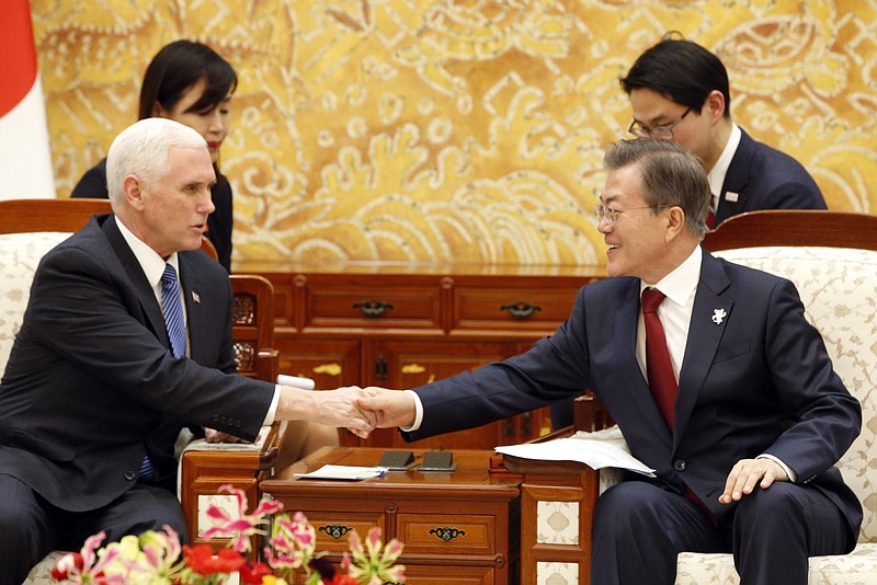 U.S. Vice President Mike Pence, left, shakes hands with South Korean President Moon Jae-in during their meeting at the presidential office Blue House in Seoul Thursday, Feb. 8, 2018. (Kim Hee-chul/Pool Photo via AP)