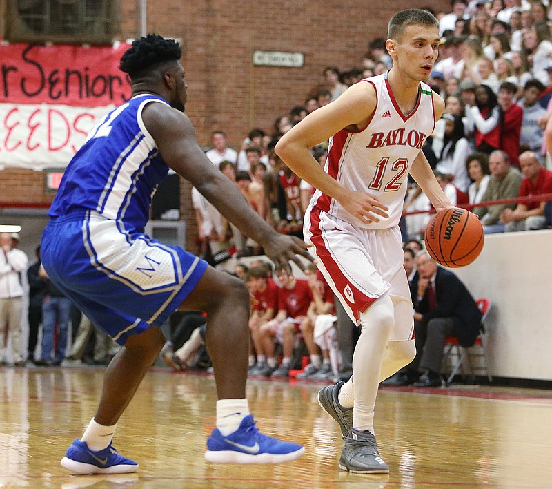 McCallie's Jorden Starling (42) guards Baylor's Boris Ristanovic (12) as he dribbles the ball downcourt during the archrivals' Division II-AA East/Middle matchup Friday at Baylor. Both scored in double figures in Baylor's 55-53 victory.