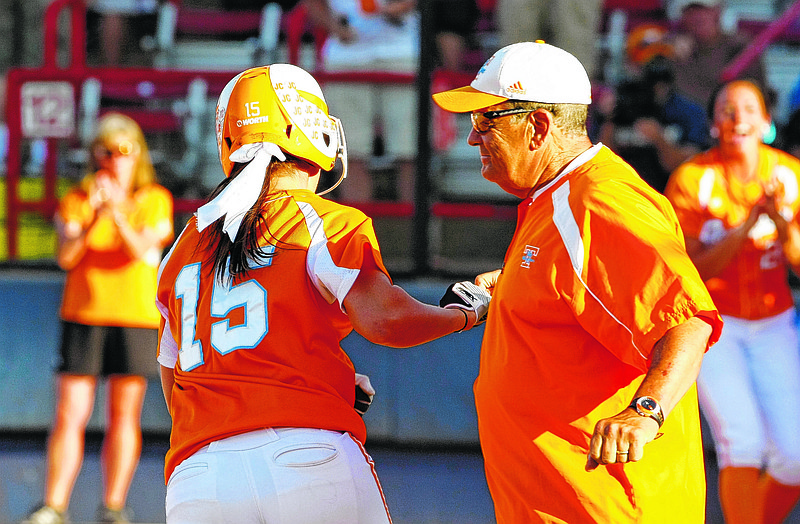 Tennessee's Melissa Davin high fives co-head coach Ralph Weekly on the way to home plate after a hitting a home run  against Alabama during the first inning of a Women's College World Series softball game in Oklahoma City, Thursday, May 31, 2012. Alabama won 5-3. (AP Photo/Alonzo Adams)