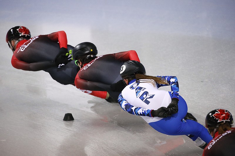 FILE - In this Feb. 3, 2018, file photo, wearing an Olympic uniform with the logo OAR - Olympic Athlete from Russia, Russian short track speed skater Ekaterina Efremenkova rounds the track with Canadian skaters during a training session.