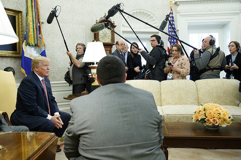 President Donald Trump speaks to reporters in the Oval Office of the White House, Friday, Feb. 9, 2018, in Washington. (AP Photo/Evan Vucci)