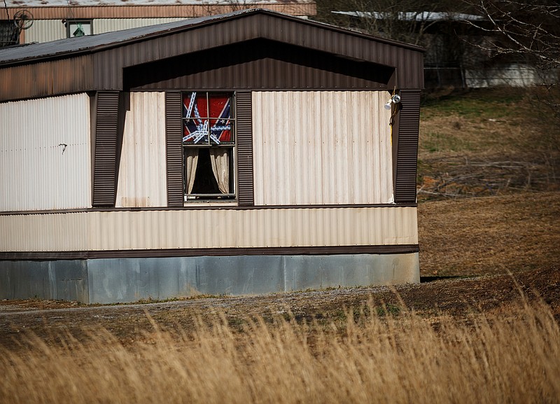 A confederate flag hangs in the window of a trailer near property purchased by Angela Johnson, who is associated white supremacist group Wotans Nation, on Friday, Feb. 9, 2018, in Meigs County, Tenn. Johnson has purchased a 44-acre property in Meigs County.
