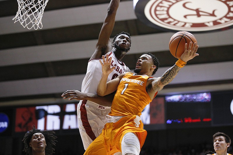 Alabama forward Donta Hall defends against Tennessee guard Lamonte Turner, right, during the first half of an NCAA college basketball game Saturday, Feb. 10, 2018, in Tuscaloosa, Ala. (AP Photo/Brynn Anderson)