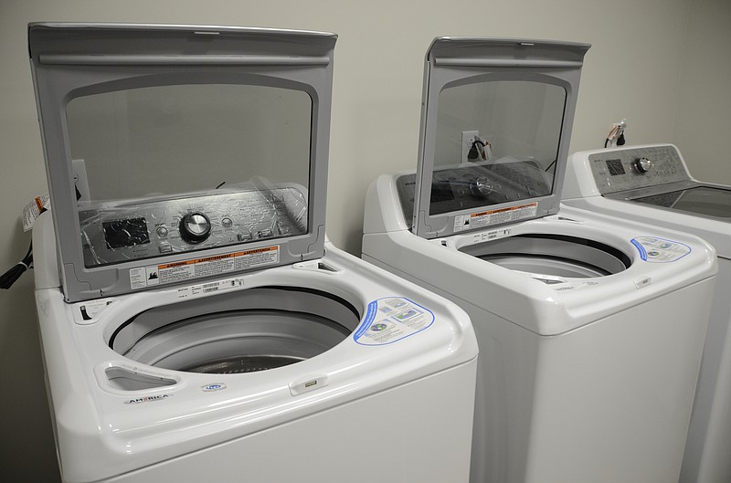 In this Monday, Dec. 22, 2014, staff file photo, the MaClellan Shelter for Families are preparing to host three families on their first night of operation. The shelter will provide washers and dryers for families to do their own laundry in Chattanooga, Tenn.