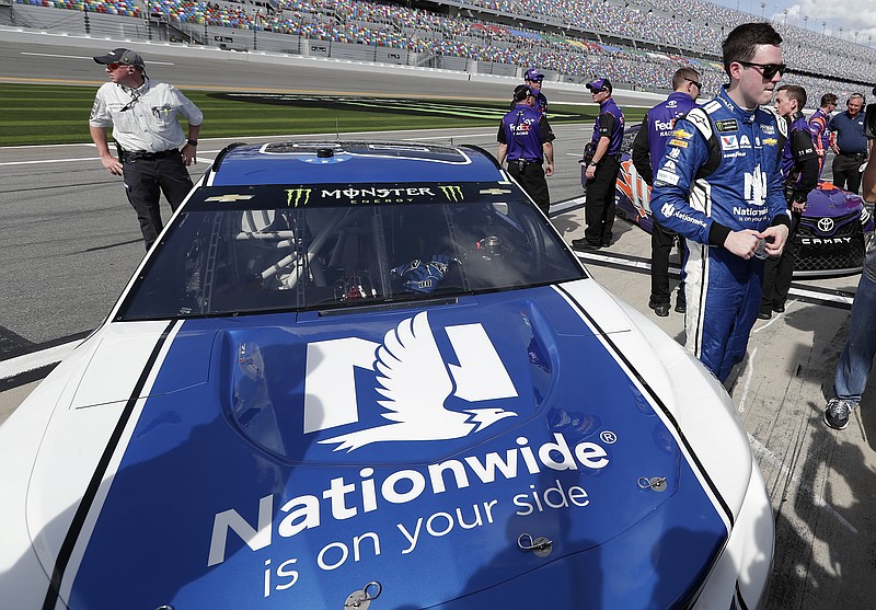 Alex Bowman, right, stands by his car on pit road after he won the pole position during qualifying for the NASCAR Daytona 500 auto race at Daytona International Speedway, Sunday, Feb. 11, 2018, in Daytona Beach, Fla. (AP Photo/John Raoux)