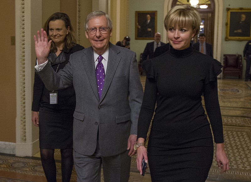 Senate Majority Leader Mitch McConnell, R-Ky., center, could afford to feel happy Friday after the Senate passed a budget deal and spending measure to reopen the federal government.